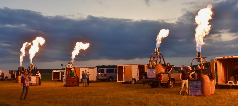 Balloon teams light up the night sky Sept. 14 as they ignite their burners with propane.