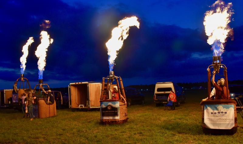 Propane flames light up the festival grounds.
