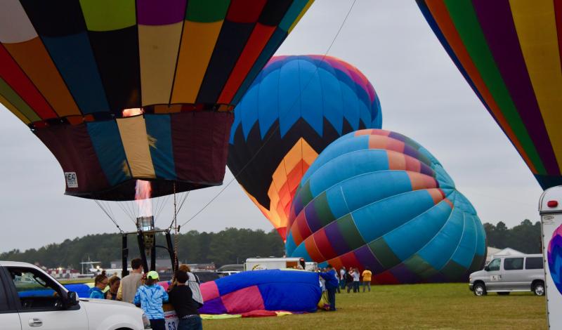 As each balloon is inflated, it takes off with the wind pushing balloon teams northeast.