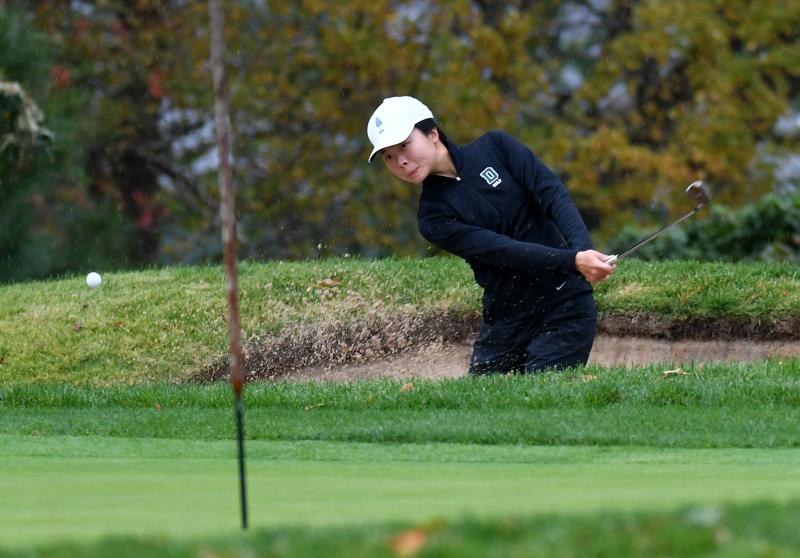 Angela Zhang smashes out of the sand during the Lady Blue Hen tournament.