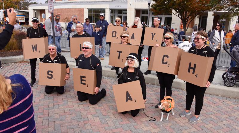 Sea Witch Parade watchers spell out the festival using Scrabble pieces. RON MACARTHUR PHOTO