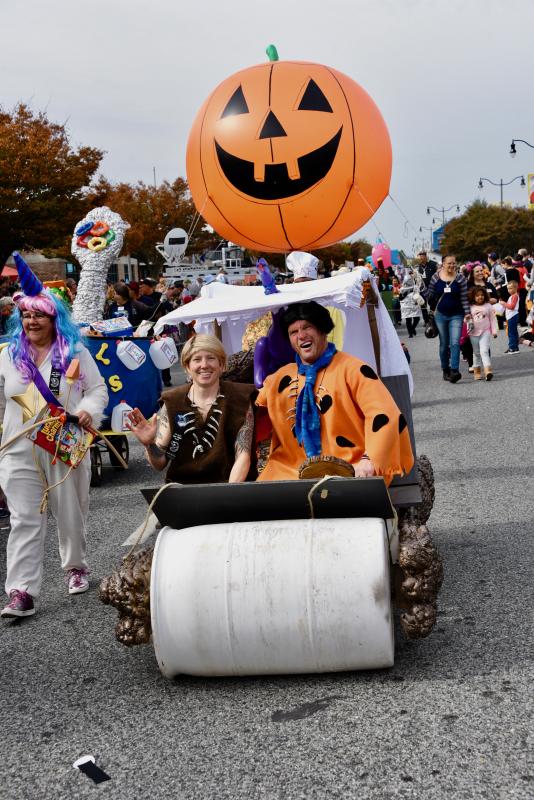 Fred and Wilma Flintstone push their “prehistoric car” down Rehoboth Avenue. RON MACARTHUR PHOTO