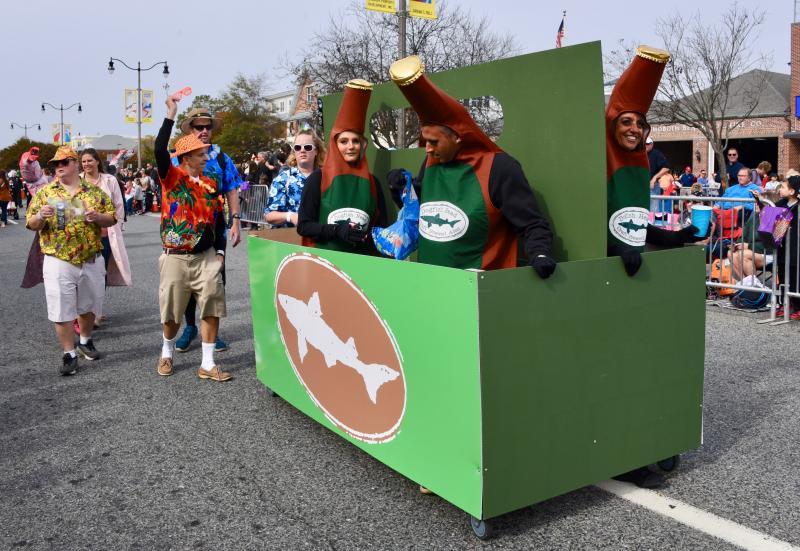 Dogfish Head employees are pushing a larger-than-life-four-pack down Rehoboth Avenue. RON MACARTHUR PHOTO