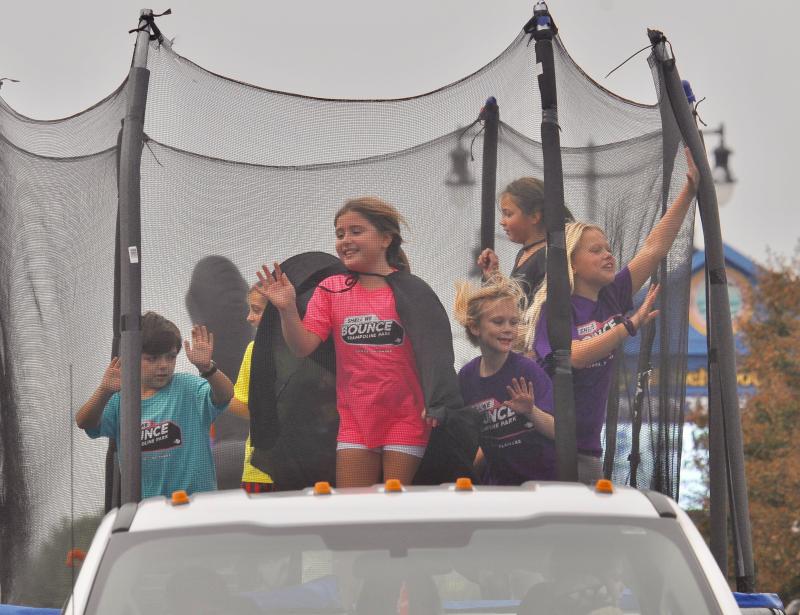 Having the most fun of anyone, youngsters jump on a Shell We Bounce trampoline during the parade. RON MACARTHUR PHOTO