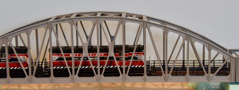 A Rock Island Line engine crosses a bridge on the second tier of the layout.