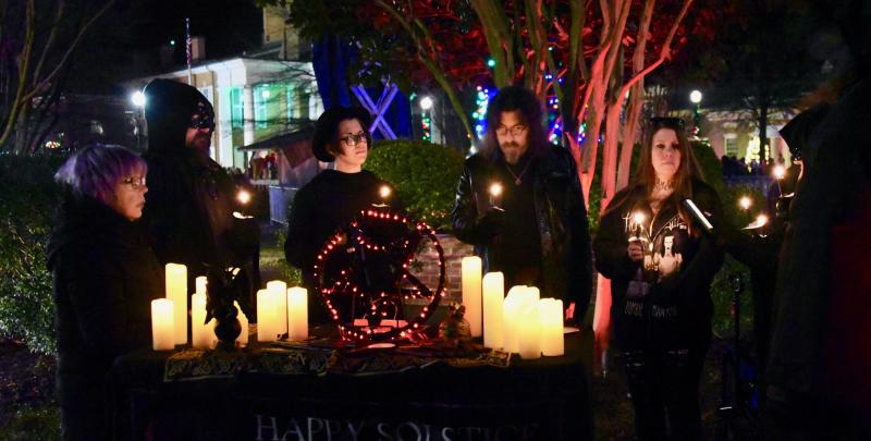 Members of First State Satanists hold a candlelight vigil at the same time as a living nativity.