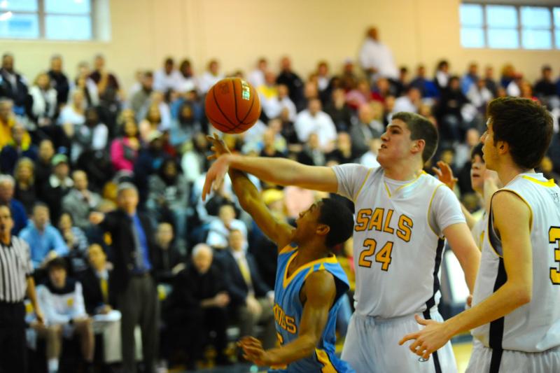 Not today! Sallies player Brian O’Neill sends Tyreik Burton’s shot into the student section. Burton showed up, scoring 19 points. O’Neill went on to star in football for Pitt and the Minnesota Vikings. DAVE FREDERICK PHOTO