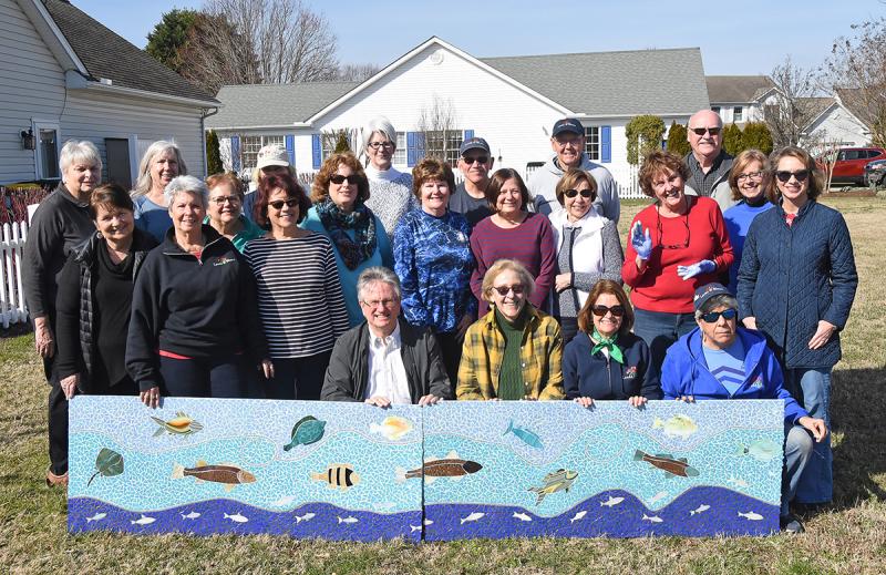 Art in Bloom volunteers gather behind two completed panels of the mosaic. Shown in back are (l-r) Susan Crawford, Terry Lake, Robin Snow, Marilyn Vai, Mardi Thompson, Cecelia Friend, Daniela Lindsjo, Laura McGrew, Chris White, Betty Burleigh, Bud Vai, Helen Lawson, Mary Presta, Joe Rooney,, Karen Ryder, Fred Phillips, Sue Sandmeyer and Mary Pasi. In front are Ed Zygmonski, Lorelei Meanor, Cindy DeEmedio and Linda Rancourt.