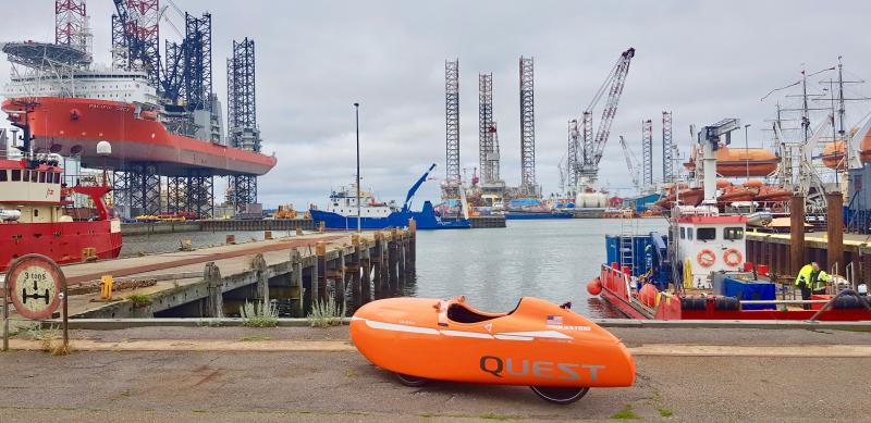 Large ships at docks in Esbjerg, Denmark, provide a backdrop to the Velomobile.