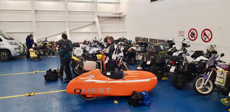 The Velomobile stands out amid the motorcycles and bicycles aboard the MS Narrona ferry between Denmark and the Faroe Islands.