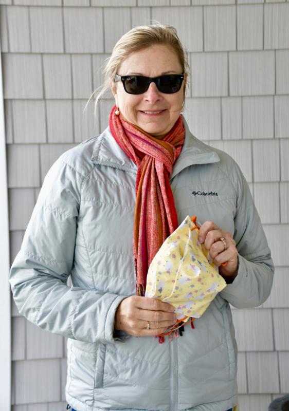 Carla Andre of Lewes delivers a handful of masks she recently completed.