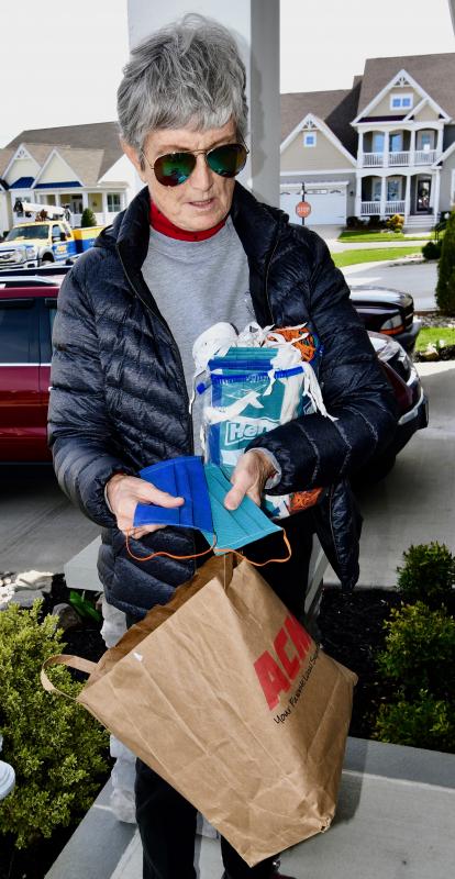 Karen Wilkens of Lewes has dozens of protective masks ready for delivery to local hospitals and EMS personnel. She also has a bag of mask donations from volunteer Chris Blake.