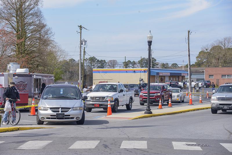 On bike, on foot and in cars, folks lined up to receive a meal.