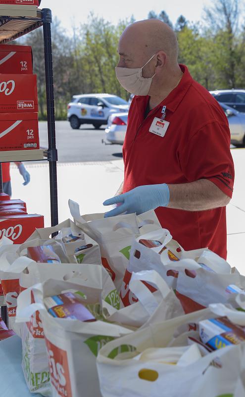 Joe Abrignani, Weis produce manager, gets ready to grab a bag.
