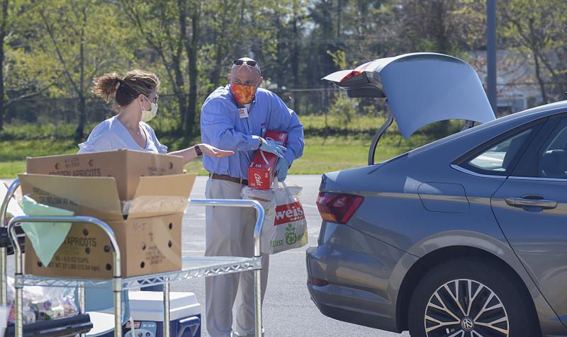 Steve Rayburn, Lewes Weis Market manager, and Dana Montgomery fill a car for deliveries.