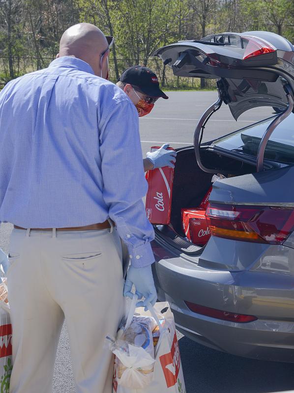Weis managers fill a car for delivery.