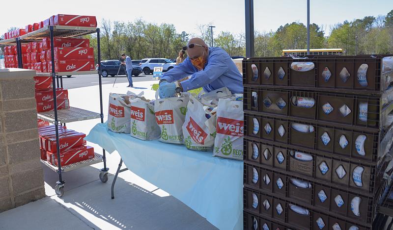 Steve Rayburn, Lewes Weis Market manager, checks over bags of food.