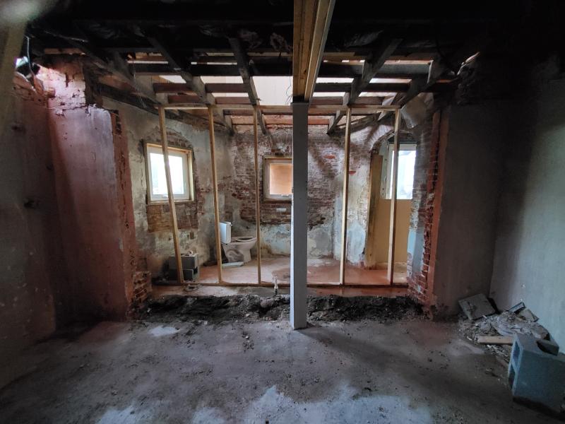 The brick foundation is exposed during the renovation in the basement.