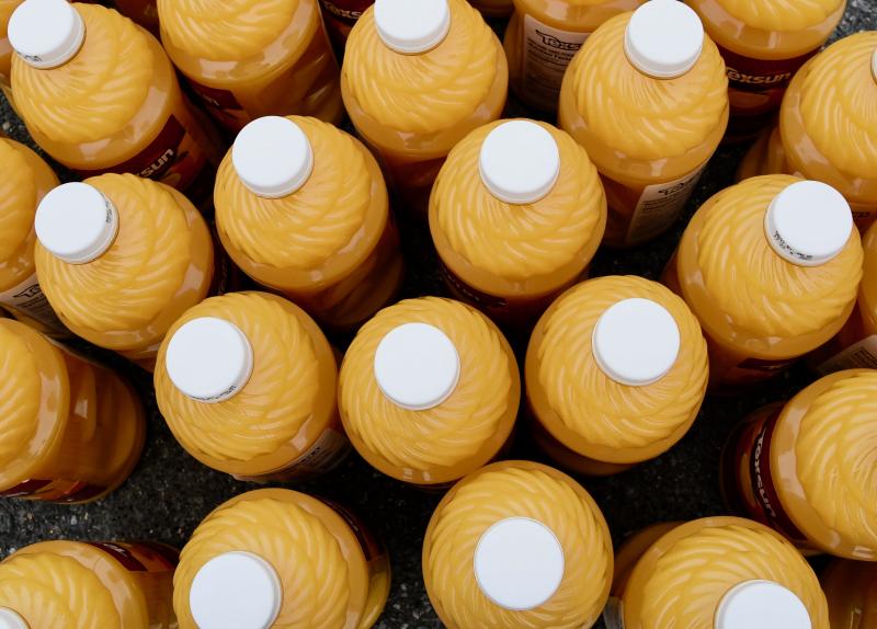 Several thousand bottles of orange drink are given away.