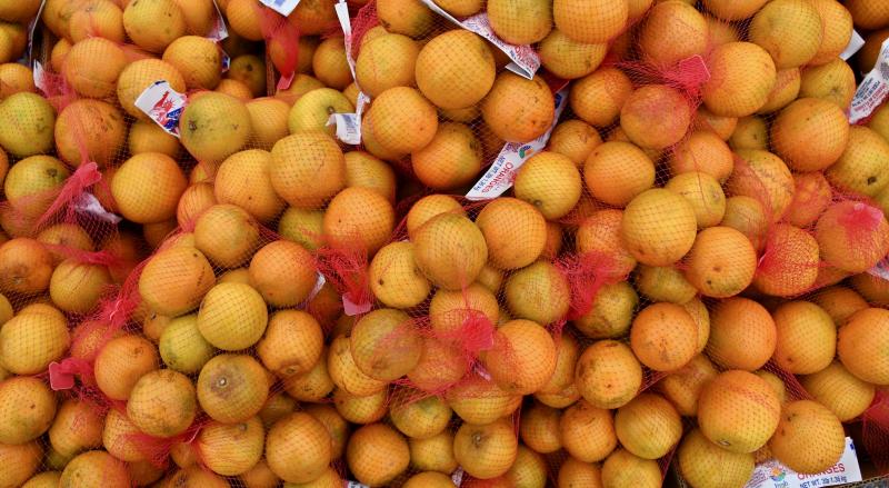 Bags of oranges are distributed to those in need.