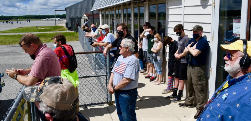 A crowd gathers outside the Delaware Coastal Airport terminal to watch the planes take off. Walt Palmer of WGMD Radio, far right, proposed the idea of a flyover.