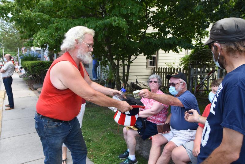 Blacksmith John Ellsworth collects money from onlookers to cover the cost of the fine.