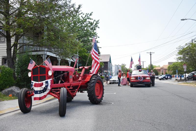 A patriotic tractor sits just in front of the stopped Doo-Dah Parade.