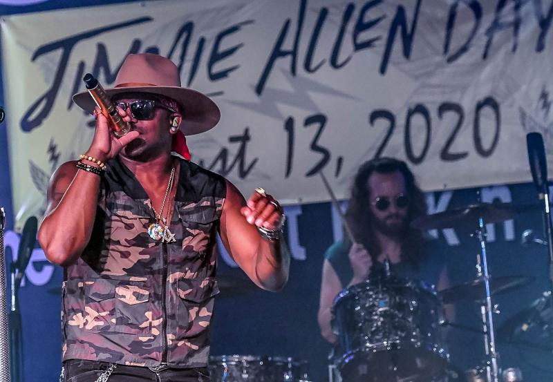 Jimmie Allen performs in front of drummer Seth Smith.