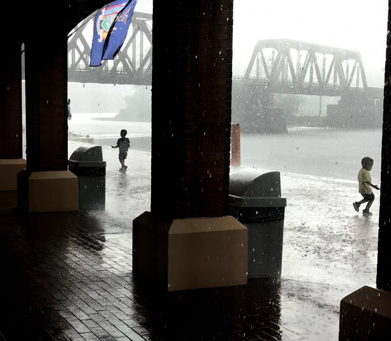 A cloudburst hit us while we waited in Waterford to start through the flight of five locks. Two young boys took advantage of the cooling rain to have some fun.