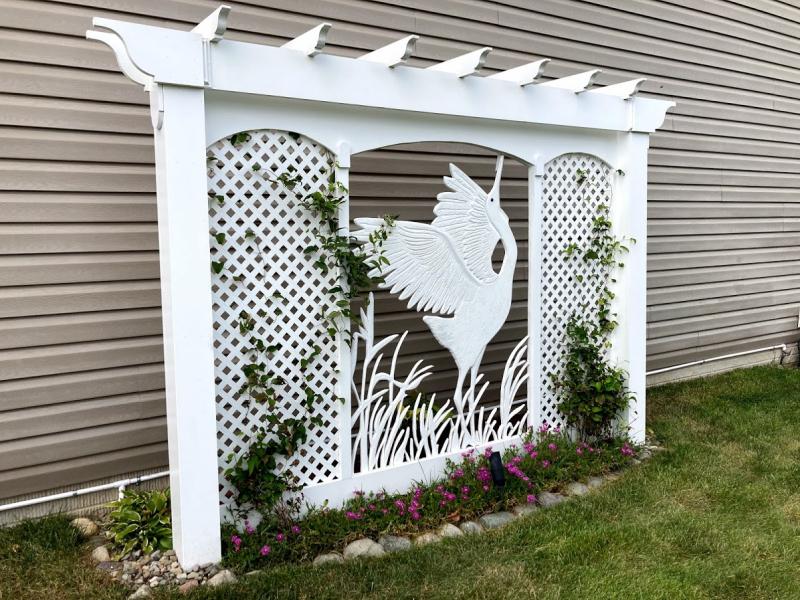 The yard is further enhanced by a white egret trellis handcrafted by Dan.