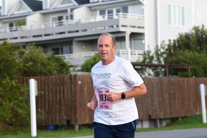 Mark Baker, a Lineman for Life, wins his age group at the Bottle & Cork 5K.