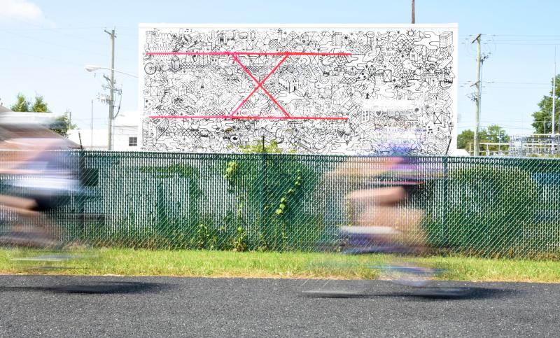 The mural is designed to grab the attention of people passing by on the trail.