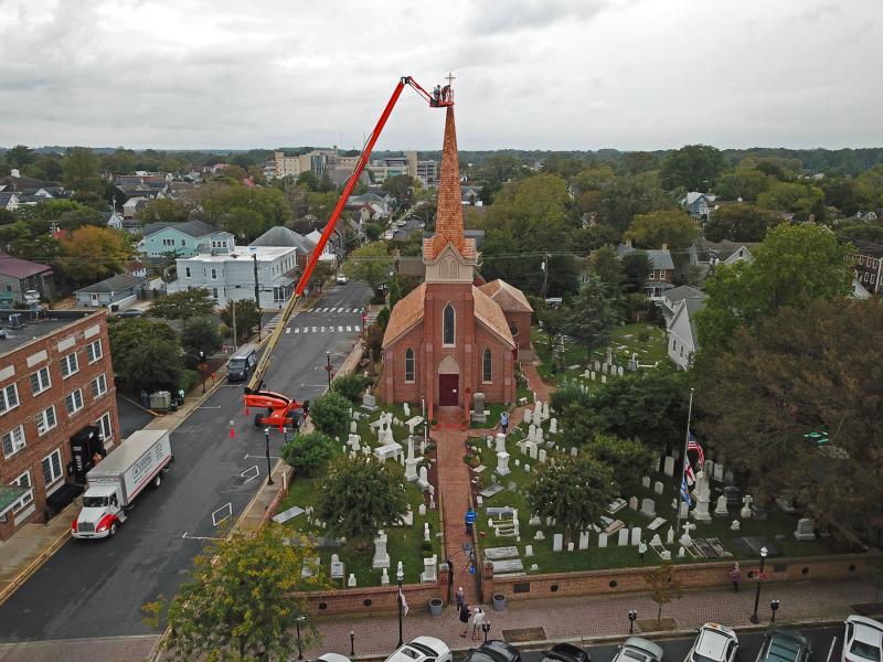 A very tall lift was utilized to attach the new cross to the steeple.
