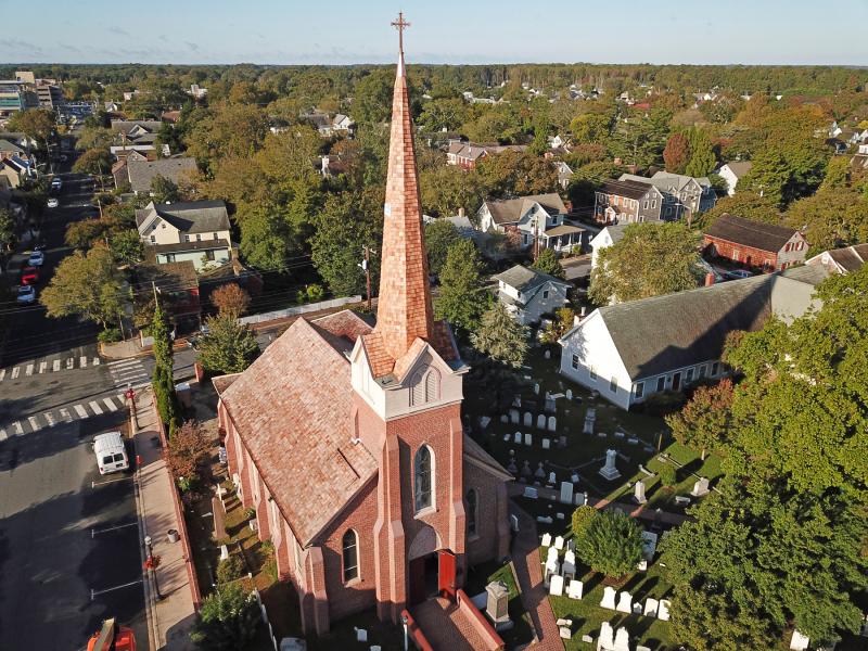 The new cross fits in nicely with the church.