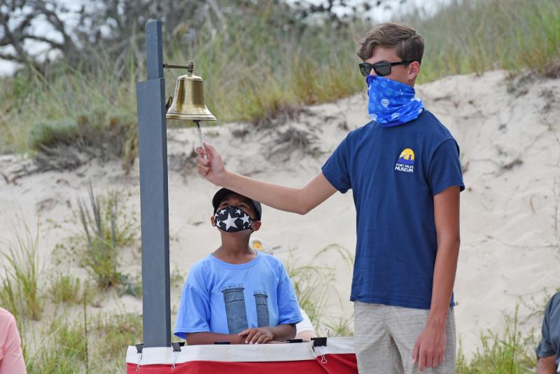 Max Wray, left, and Nic Schimmel take turns ringing the bell after each name of a Delaware soldier lost in World War II is read. NICK ROTH PHOTOS
