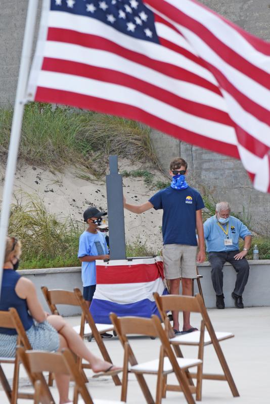 Max Wray, left, and Nic Schimmel ring a bell to honor fallen Delaware soldiers.