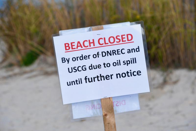 Lewes officials are placing signs at every entrance to the beach to notify the public that the beach is closed while crews clear an oil spill that washed ashore. RON MACARTHUR PHOTOS