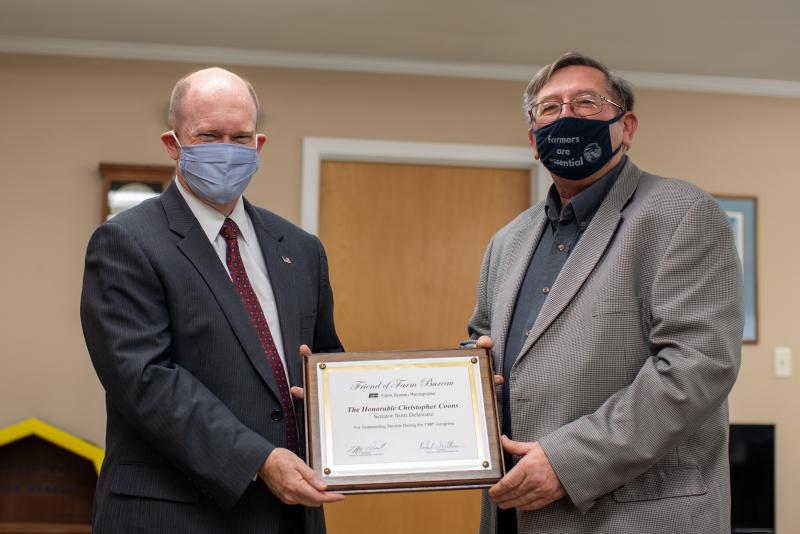 Sen. Chris Coons, left, receives the national Friend of Farm Bureau Award from President Richard Wilkins of the Delaware State Farm Bureau. SUBMITTED PHOTO