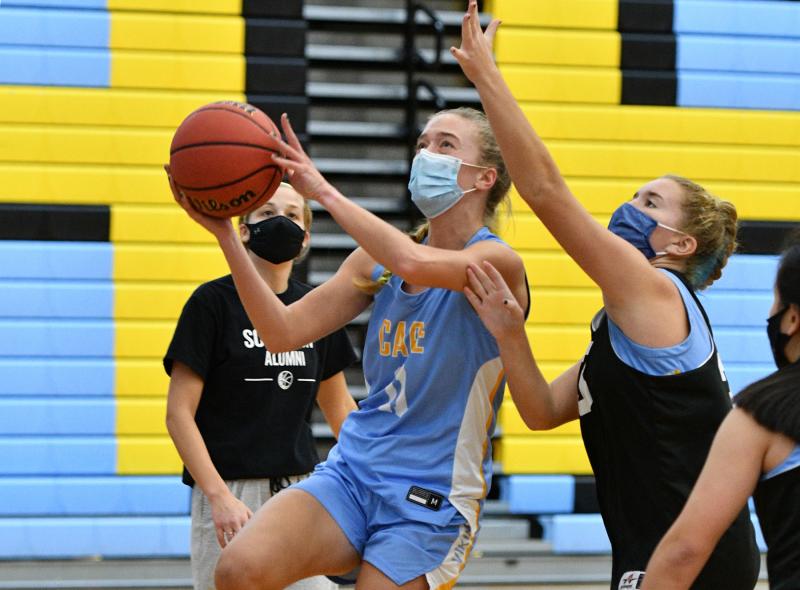 Cape basketball player Ella Rishko goes strong to the hoop defended by Kelly Bragg during a recent practice. Winter sports athletes have been practicing since Nov. 30, waiting to begin competing against other schools. DAN COOK PHOTO
