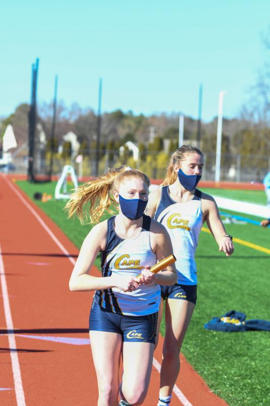 Lainey Shockro hands off to Elizabeth Melson in the 4-by-800 relay.