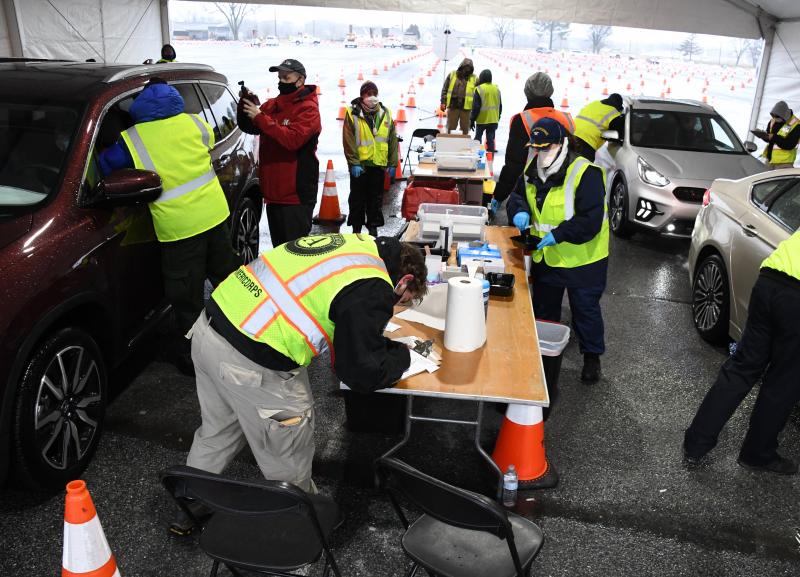 Teams work two lines in a tent to administer COVID-19 vaccine during a FEMA-coordinated drive-through event Feb. 22 at Dover International Speedway. Officials plan to vaccinate nearly 19,000 people with second doses during the six-day event. RON MACARTHUR PHOTOS