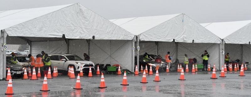 Several tents have been set up at Dover International Speedway for a mass drive-through COVID-19 vaccination clinic.