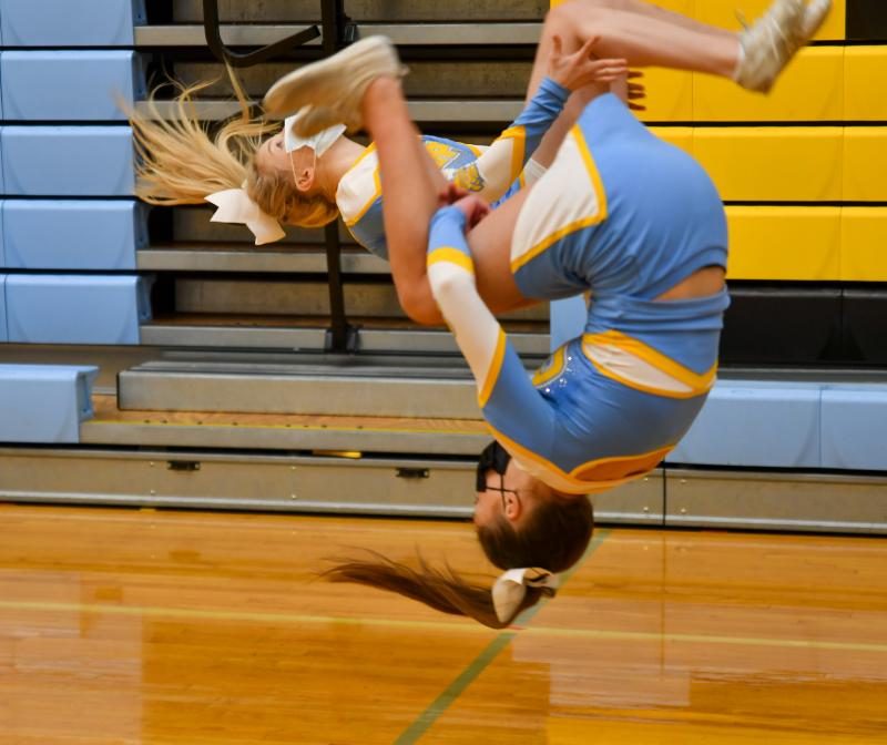 Lauren Pribulick, back, and Summer Reynolds do back tucks prior to the wrestling match Feb. 10.