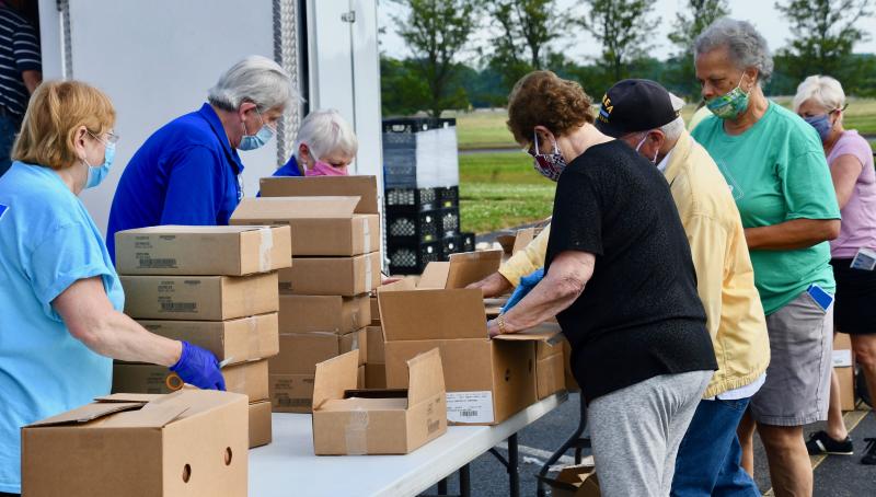 Volunteers join forces June 6, 2020, to pack and distribute 300 USDA food boxes to Sussex County senior citizens.