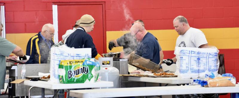 Volunteers are busy preparing oysters and the traditional fixings served at every Oyster Eat.