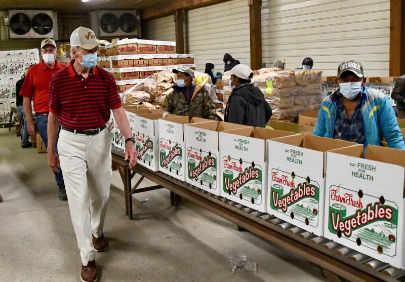 On July 8, 2020, U.S. Rep. Tom Carper visits Vincent Farms near Laurel as workers pack USDA food boxes for distribution to food banks. The program helps farmers supplement losses due to falling sales to the restaurant industry.