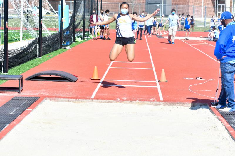 Aya Daisey takes off in the long jump.