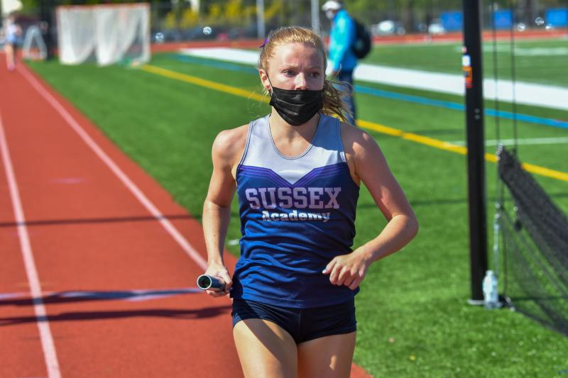 Sussex Academy’s Emily Trout runs a leg of the 4-by-800 relay.