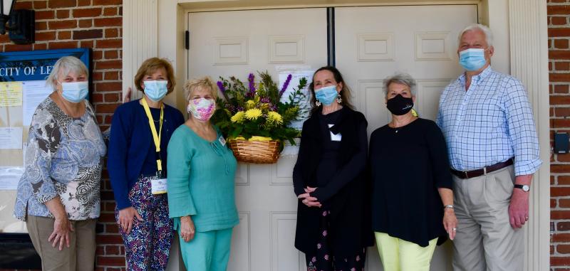 Posing with the Lewes City Hall May Day basket are (l-r) Co-chair Sue Crawford, Darce Braiman, Bonnie Mahr, Maureen Ciano, Co-chair Marilyn Vai, and Lewes Mayor Ted Becker. RON MACARTHUR PHOTO