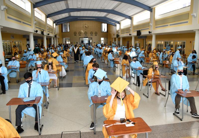 Students await the processional in the air-conditioned cafeteria.